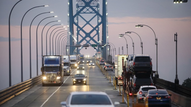Commercial trucks and passenger vehicles drive across Ambassador Bridge on the Canada-U.S. border in Windsor, Ontario, Canada, on Thursday, Aug. 9, 2018.