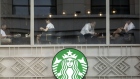 Customers sit by the windows of a Starbucks Corp. coffee shop in Shanghai, China, on Monday, July 29, 2019. Chinese trade negotiators will host their U.S. counterparts at a landmark of jazz-era Shanghai on the city's riverside Bund, re-opening trade talks with a marked change of atmosphere after an almost three-month hiatus. Photographer: Qilai Shen/Bloomberg