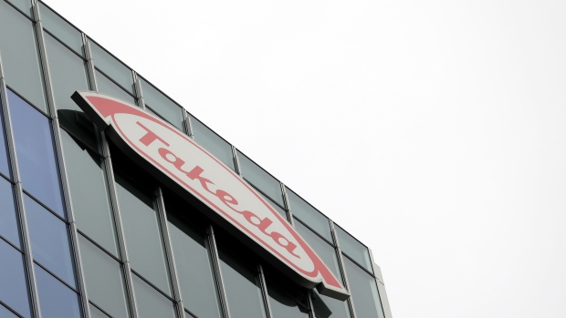 The Takeda Pharmaceutical Co. logo is displayed atop the company's global headquarters in Tokyo, Japan, on Wednesday, Dec. 5, 2018. Takeda received shareholder approval for its $62 billion acquisition of U.K.-listed Shire Plc, an endorsement of Chief Executive Officer Christophe Weber’s strategy to transform the Japanese drugmaker into a global powerhouse. Photographer: Kiyoshi Ota/Bloomberg