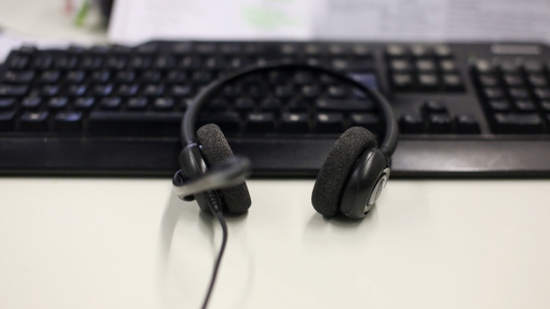 A customer service representative's telephone headset rests on a computer keyboard inside the customer service call center at First Direct bank, the online and telephone banking unit of HSBC Holdings Plc, in Leeds, U.K., on Wednesday, Feb. 26, 2014.