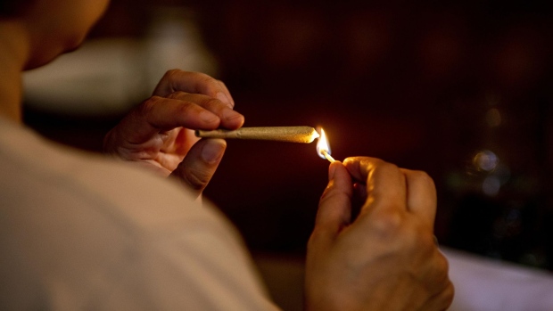 A customer lights a joint at the Lowell Cafe, a new cannabis lounge in West Hollywood, California, U.S., on Tuesday, Oct. 1, 2019. America's first cafe to allow the consumption of cannabis offers an extension to the market, where sales are largely confined to dispensaries and online orders, and tests the appetite for a more open and public consumption of a product that's still illegal in many jurisdictions. Photographer: Kyle Grillot/Bloomberg