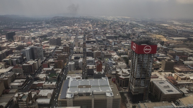 Commercial buildings, including offices of Absa Group Ltd., right, stand on the city skyline in the the Central Business District (CBD) of Johannesburg, South Africa, on Thursday, Oct. 10, 2019. South Africa's economy remains stuck in its longest downward cycle since 1945, adding to pressure on the government to implement reforms to lift business confidence and boost growth. Photographer: Guillem Sartorio/Bloomberg