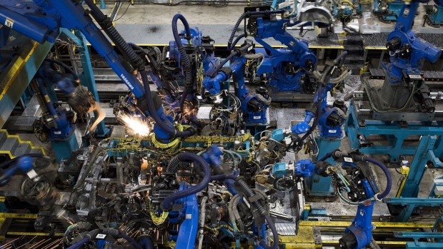 Sparks fly as robotic arms perform inner frame welds for 2018 Honda Accord vehicles during production at the Honda of America Manufacturing Inc. Marysville Auto Plant in Marysville, Ohio, U.S., on Thursday, Dec. 21, 2017. More than three decades after Honda Motor Co. first built an Accord sedan at its Marysville factory in 1982, humans are still an integral part of the assembly process -- and that's unlikely to change anytime soon. Photographer: Ty Wright/Bloomberg