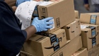 An employee arranges Amazon.com Inc. packages before delivery at the United States Postal Service (USPS) Joseph Curseen Jr. and Thomas Morris Jr. processing and distribution center in Washington, D.C., U.S., on Tuesday, Dec. 12, 2017. The USPS said it expects to deliver over 15 billion total pieces of mail this holiday season with expanded Sunday delivery operations in certain areas, delivering over six million packages each Sunday in December. Photographer: Andrew Harrer/Bloomberg