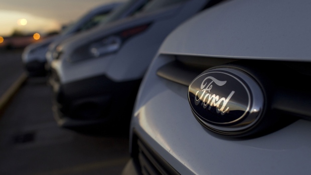 A Ford badge sits on a finished Kuga SUV automobile in a parking lot ahead of distribution at the Ford Espana SL plant, operated by Ford Motor Co., in Almusafes, Spain.