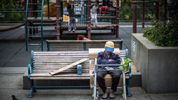 An elderly person sits on a bench in the Chinatown neighborhood of San Francisco, California, U.S., on Tuesday, June 19, 2018. The Labor Department rule, aka the fiduciary rule conceived by the Obama administration, was meant to ensure that advisers put their clients' financial interests ahead of their own when recommending retirement investments has been killed by the Trump administration. Photographer: David Paul Morris/Bloomberg