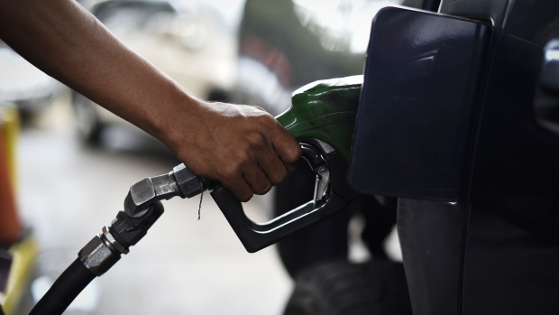 An employee refuels a vehicle at a Petroleos de Venezuela SA (PDVSA) gas station in Caracas, Venezuela, on Tuesday, Jan. 29, 2019. President Donald Trump sanctioned Venezuela's state-owned oil company PDVSA and its central bank on Monday, the latest U.S. move intended to raise pressure on the regime of President Nicolas Maduro. Photographer: Carlos Becerra/Bloomberg