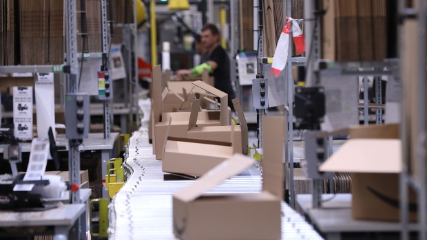 Empty cardboard boxes pass along a conveyor from the packing station at an Amazon.com Inc. fulfilment center during the online retailer's Prime Day sales promotion day in Koblenz, Germany, on Monday, July 15, 2019. Amazon is tapping high-profile actors, athletes and social-media sensations like never before to maintain buzz around its Prime Day summer sale, now in its fifth year and battling increasing competition from rivals. Photographer: Krisztian Bocsi/Bloomberg