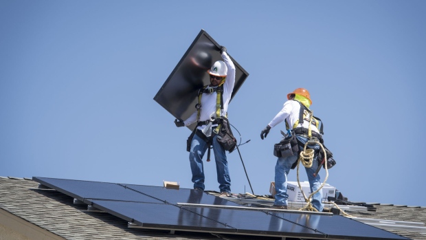 Contractors install Sunrun Inc. solar panels on the roof of a new home at the Westline Homes Willowood Cottages community in Sacramento, California, U.S., on Wednesday, Aug. 15, 2018.