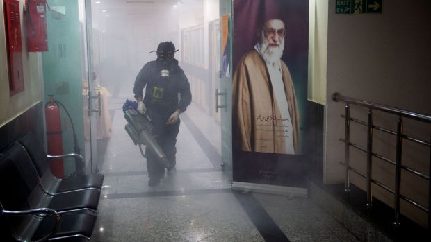 A firefighter uses a fog machine to disinfect the city hall building following the outbreak of coronavirus in Tehran. Photographer: Ali Mohammadi/Bloomberg