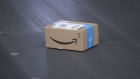 The Amazon.com Inc. logo sits on a sealed box on a conveyor inside an Amazon.com Inc. fulfilment center during the online retailer's Prime Day sales promotion day in Koblenz, Germany, on Monday, July 15, 2019. Amazon is tapping high-profile actors, athletes and social-media sensations like never before to maintain buzz around its Prime Day summer sale, now in its fifth year and battling increasing competition from rivals. Photographer: Krisztian Bocsi/Bloomberg
