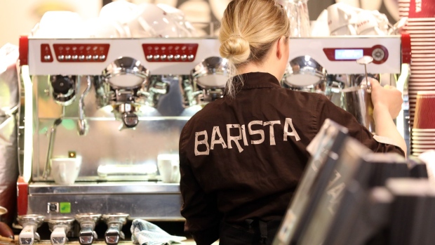 A barista uses a coffee machine to froth a container of milk behind the counter of a Costa Coffee shop, operated by Whitbread Plc, in London, U.K., on Wednesday, May 2, 2018. Whitbread is betting that its faster-growing Costa Coffee chain will compete more effectively against the likes of Starbucks Corp. once separated from the company's hotel business. Photographer: Chris Ratcliffe/Bloomberg