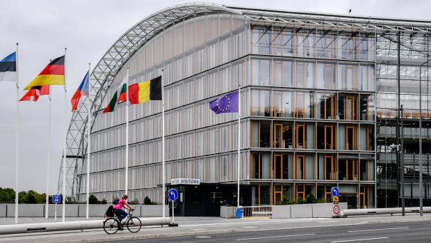 A cyclist rides outside the European Investment Bank in Luxembourg. Photographer: Geert Vanden Wijngaert/Bloomberg