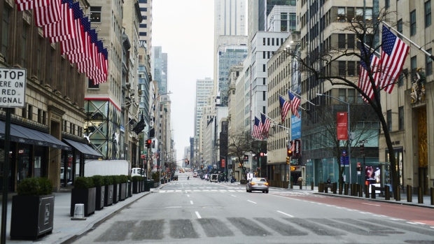 A lone car drives in a Midtown neighborhood of New York on March 20. Photographer: Gabby Jones/Bloomberg