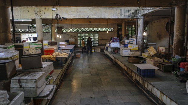 People walk through a closed meat and fish market in Mumbai, India, on Wednesday, March 25, 2020. India imposed a three-week long nationwide lockdown for its 1.3 billion people, the most far-reaching measure undertaken by any government to curb the spread of the coronavirus pandemic. Photographer: Dhiraj Singh/Bloomberg