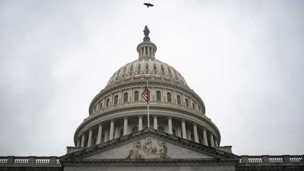A bird flies over the U.S. Capitol on March 23. Photographer: Al Drago/Bloomberg