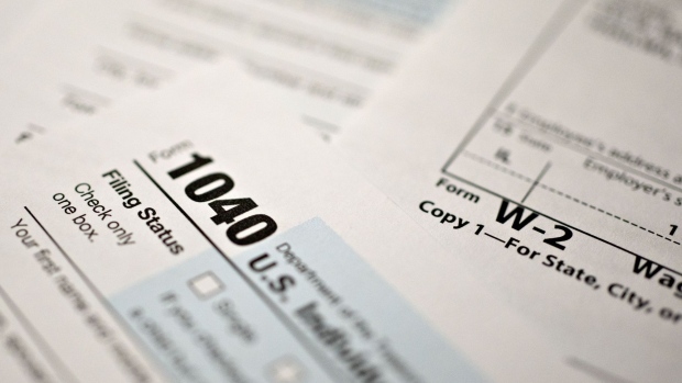 A U.S. Department of the Treasury Internal Revenue Service (IRS) 1040 Individual Income Tax form for the 2019 tax year is arranged for a photograph with a W-2 wage statement in Tiskilwa, Illinois, U.S., on Friday, March 20, 2020. Tax forms and payments wont be due to the Internal Revenue Service until July 15 this year, Treasury Secretary Steven Mnuchin said in a tweet, as the government looks for ways to respond to the coronavirus. Photographer: Daniel Acker/Bloomberg