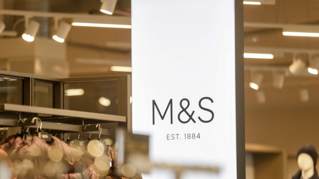 The M&S logo stands illuminated on a sign inside Marks and Spencer Group Plc's newly opened store in Fraddon, U.K. on Wednesday, Oct. 23, 2019. Marks & Spencer plans to open more large food stores, shifting away from a strategy of expanding smaller convenience outlets as it prepares for an alliance with online grocer Ocado Group Plc. Photographer: James Beck/Bloomberg