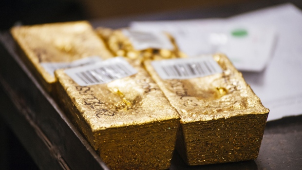 Gold bullion bars sit following casting at the Rand Refinery Ltd. plant in Germiston, South Africa, on Wednesday, Aug. 16. 2017. Established by the Chamber of Mines of South Africa in 1920, Rand Refinery is the largest integrated single-site precious metals refining and smelting complex in the world, according to their website. Photographer: Waldo Swiegers/Bloomberg