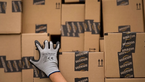 An employee loads a truck with boxes to be shipped at the Amazon.com Inc. distribution center in Phoenix, Arizona, U.S.