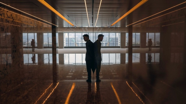A man is reflected as he stands at an elevator lobby inside The Exchange 106 tower at the Tun Razak Exchange (TRX) financial district in Kuala Lumpur, Malaysia, Wednesday, Oct. 23, 2019. Southeast Asia's tallest skyscraper was once shadowed by the 1MDB scandal that has upended the nation's politics and implicated global banks in criminal cases. It now seeks to shed that past by plying prospective tenants with marble walls and mirrored ceilings. Photographer: Joshua Paul/Bloomberg
