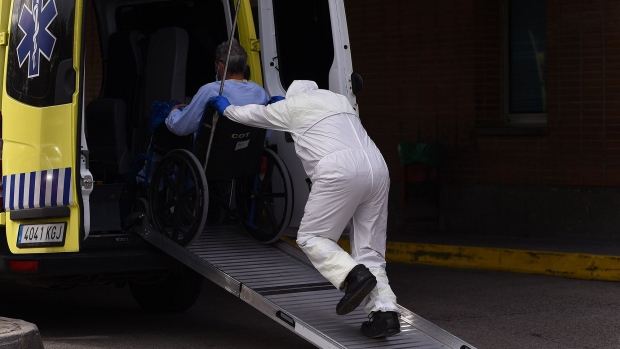 MADRID, SPAIN - MARCH 27: A hospital worker wheels a coronavirus patient into a waiting ambulance to be taken to another sanitary center at the Severo Ochoa hospital on March 27, 2020 in Madrid, Spain. Spain recorded 769 deaths and 36,000 hospitalized from the Coronavirus in the last 24 hours as it plans to continue its quarantine measures at least through April 11. The Coronavirus (COVID-19) pandemic has spread to many countries across the world, claiming over 20,000 lives and infecting hundreds of thousands more. (Photo by Denis Doyle/Getty Images)