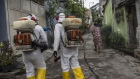 Workers disinfect a street surrounding a hospital in Niteroi, Brazil. Photographer: Dado Galdieri/Bloomberg