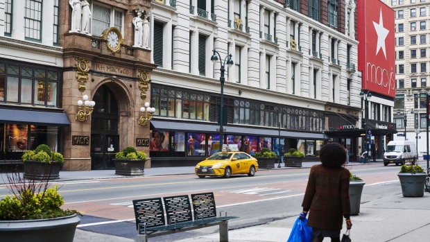Pedestrians pass in front of a Macy's Inc. store in the Midtown neighborhood of New York, U.S., on Friday, March 20, 2020. 