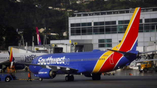 A Southwest Airlines Co. Boeing Co. 737-800 jet aircraft taxis on the tarmac at San Francisco International Airport (SFO) in San Francisco, California, U.S., on Wednesday, March 27, 2019. The ban on Boeing 737 Max flights plus soft leisure-travel demand will shave $150 million from Southwest's first-quarter revenue. Photographer: Patrick T. Fallon/Bloomberg