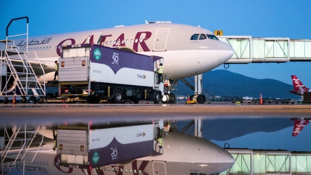 A Qatar Airways Ltd. aircraft sits connected to a passenger boarding bridge at Chiang Mai International Airport in Chiang Mai, Thailand. Photograph: Taylor Weidman/Bloomberg