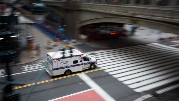An NYU Langone Health ambulance drives past Grand Central Station in New York, U.S., on Monday, March 30, 2020. Roughly 37,500 people have tested positive for the coronavirus in New York City, officials said on Monday, up about 3,700 from a day earlier. Photographer: Michael Nagle/Bloomberg