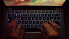 A person uses a laptop computer with illuminated English and Russian Cyrillic character keys in this arranged photograph in Moscow, Russia, on Thursday, March 14, 2019. Russian internet trolls appear to be shifting strategy in their efforts to disrupt the 2020 U.S. elections, promoting politically divisive messages through phony social media accounts instead of creating propaganda themselves, cybersecurity experts say.