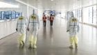 Airport employees wear full body protective suits at Pudong International Airport in Shanghai 