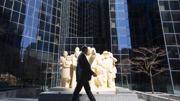 A pedestrian walks past a sculpture on McGill College Avenue in Montreal, Quebec, Canada, on Friday, March 27, 2020. Quebec Premier Francois Legault said he’s putting Quebec “on pause” to limit the coronavirus outbreak and stem physical contact. Photographer: Christinne Muschi/Bloomberg