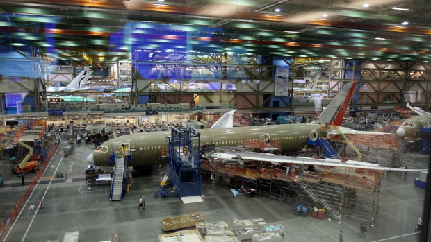 Employees work on the assembly line of the Boeing Co. 787 Dreamliner airplane, the first that will fly, at the company's manufacturing plant in Everett, Washington, U.S., on Thursday, April 30, 2009. Boeing Co. said it stopped work more than a month ago on two sections for the 787 Dreamliner after tiny wrinkles were discovered in the composite-material fuselages supplied by Italian vendor Alenia Aeronautica. Photographer: KEVIN P.CASEY/Bloomberg News
