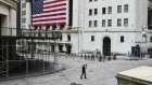 A pedestrian films himself while walking past the New York Stock Exchange (NYSE) on a nearly empty Wall Street in the Financial District of New York, U.S., on Monday, March 30, 2020. Roughly 37,500 people have tested positive for the coronavirus in New York City, officials said on Monday, up about 3,700 from a day earlier. Photographer: Gabby Jones/Bloomberg