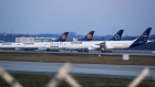 Passenger aircraft, operated by Deutsche Lufthansa AG, sit grounded on the closed north west runway at Frankfurt Airport, operated by Fraport AG, in Frankfurt, Germany, on Thursday, March 26, 2020. Unable to fill planes with passengers as the coronavirus destroys travel demand, airlines are instead using their fleets to transport more cargo, including medicines, smartphones and Korean strawberries. Photographer: Alex Kraus/Bloomberg
