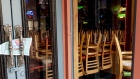 Chairs are stacked on tables in a closed restaurant on Bourbon Street in New Orleans, Louisiana, U.S., on Monday, March 30, 2020. 