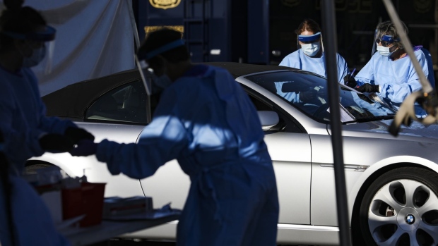 Medical workers test a resident at a drive-through testing site in the parking lot of Raymond James Stadium in Tampa on April 2. Photographer: Eve Edelheit/Bloomberg