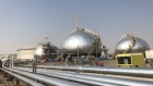 Three-phase spheroids stand behind pipelines at Saudi Aramco's crude oil processing facility in Abqaiq, Saudi Arabia. Photographer: Dina Khrennikova/Bloomberg