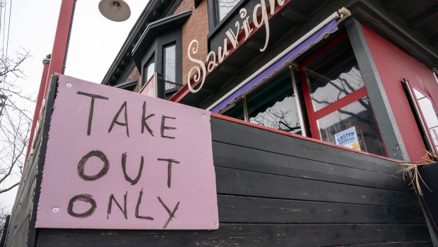 A restaurant in Toronto displays a "Take Out Only" sign on Wednesday, March 18, 2020. 