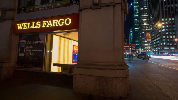 A Wells Fargo & Co. bank branch stands at night in New York, U.S., on Saturday, April 11, 2015. Photographer: Craig Warga