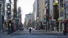 A pedestrian walks down Saint-Catherine Street in Montreal on March 27. Photographer: Christinne Muschi/Bloomberg