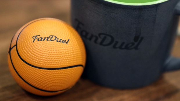 A mini basketball and a coffee mug sit on an employee's desk at Fanduel offices. Photographer: Chris Ratcliffe/Bloomberg