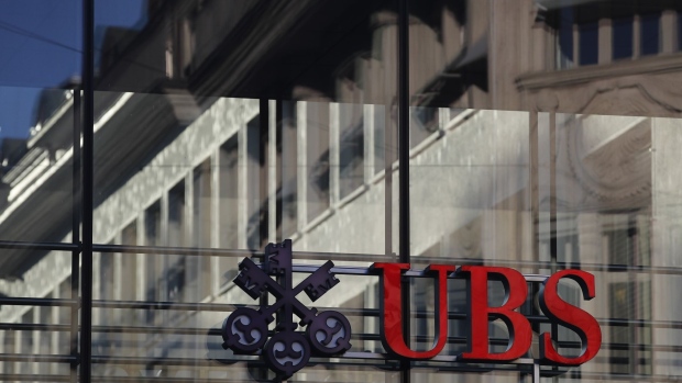 A company logo is displayed on a walkway at the UBS headquarters in Zurich, Switzerland, on Monday, Oct. 14, 2019. The spying scandal roiling Credit Suisse Group AG has also created a big headache at UBS a stone's throw away in Zurich: What to do about its star hire Iqbal Khan. Photographer: Stefan Wermuth/Bloomberg