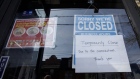 A closed sign is displayed on the door of a restaurant in Toronto on March 25. 