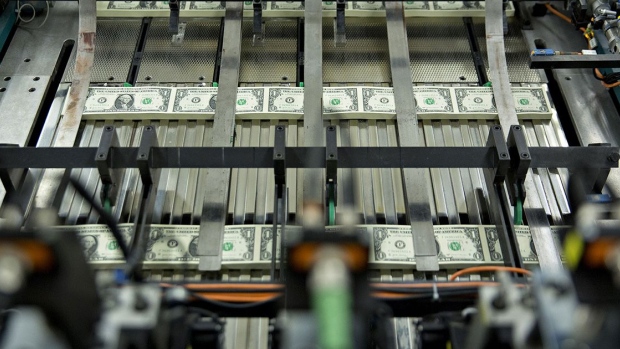 Stacks of $1 dollar notes bearing the name of U.S. Treasury Secretary Steven Mnuchin move through a machine at the U.S. Bureau of Engraving and Printing in Washington, D.C., U.S., on Wednesday, Nov. 15, 2017. Photographer: Andrew Harrer/Bloomberg