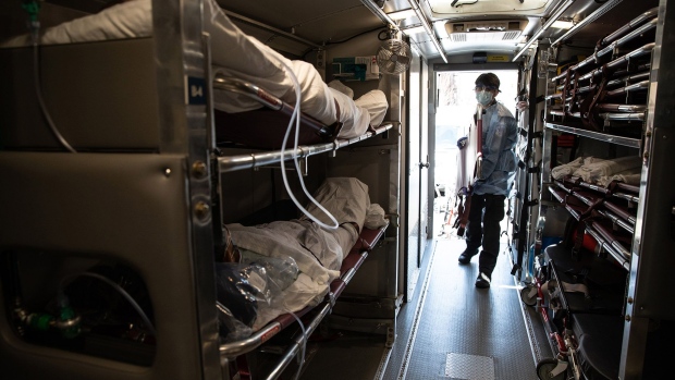 A medic prepares to unload COVID-19 patients arriving to the Montefiore Medical Center Moses Campus in the Bronx borough of New York City on April 7.