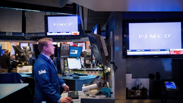 A trader works as Pacific Investment Management Co. (PIMCO) signage is displayed on the floor of the New York Stock Exchange (NYSE) in New York, U.S., on Wednesday, Dec. 21, 2016.  