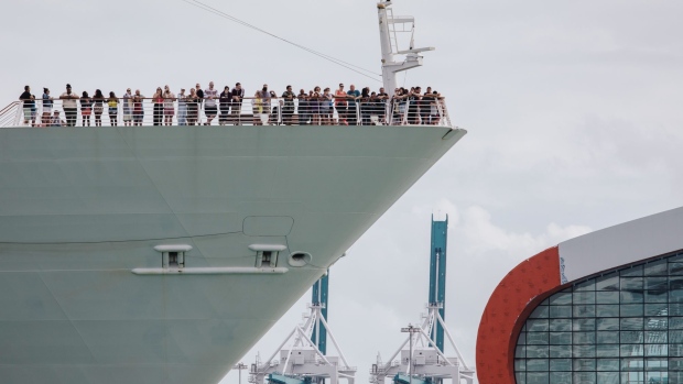 Passengers stand on board the Royal Caribbean's Navigator Of The Seas cruise ship at the Port of Miami on March 9. Photographer: Jayme Gershen/Bloomberg